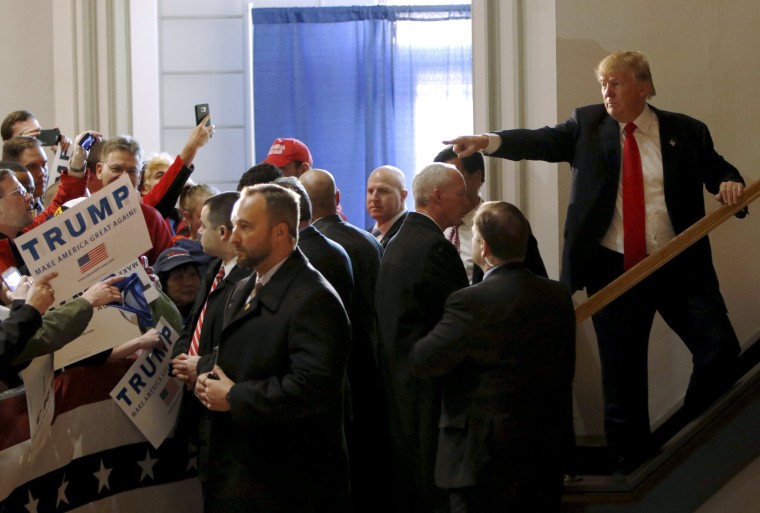 Image: U.S. Republican presidential candidate Trump points at a supporter as he leaves the building after speaking at a campaign event at the Veterans Memorial Building in Cedar Rapids