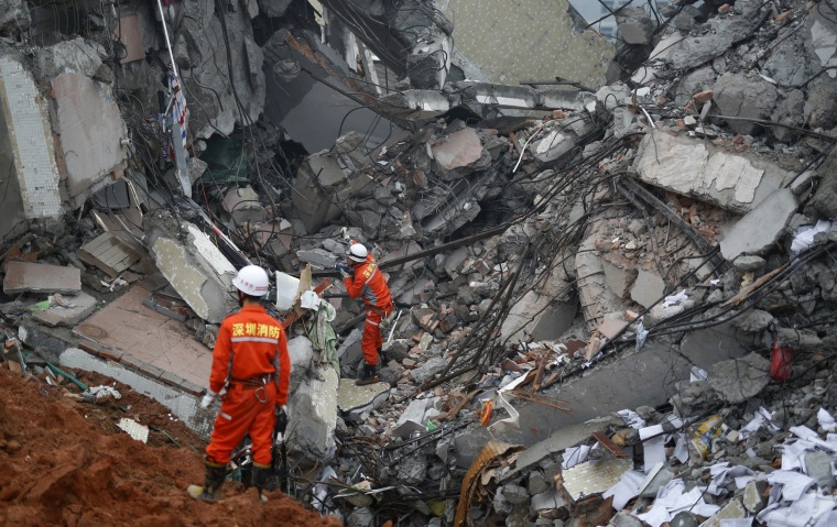 Image: Firefighters search for survivors among the debris of collapsed buildings after a landslide hit an industrial park in Shenzhen, Guangdong province, China