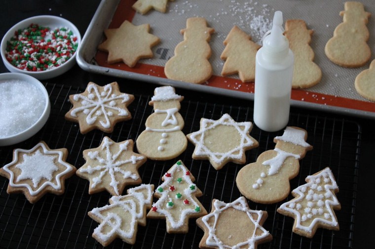How to Decorate Sugar Cookies: Transfer the white glaze to glaze to a piping bag or squeeze bottle with a tiny tip and pipe designs all over the cookies