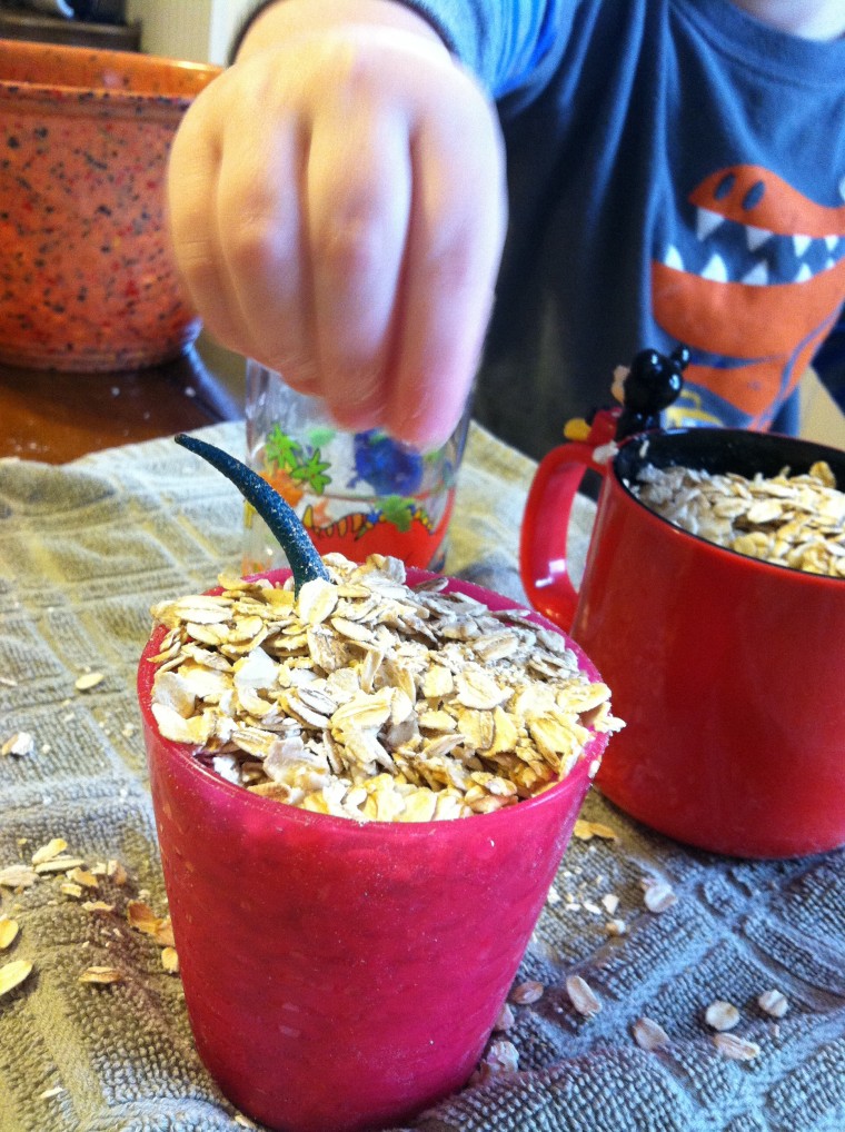 Child playing with dried oats