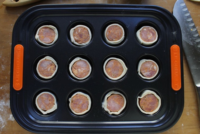 How to Make Sausage Puffs: Place the slices in the cups of three mini-muffin trays