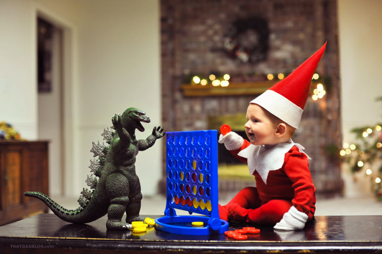 Rockwell the elf enjoys a game of Checkers with Godzilla.
