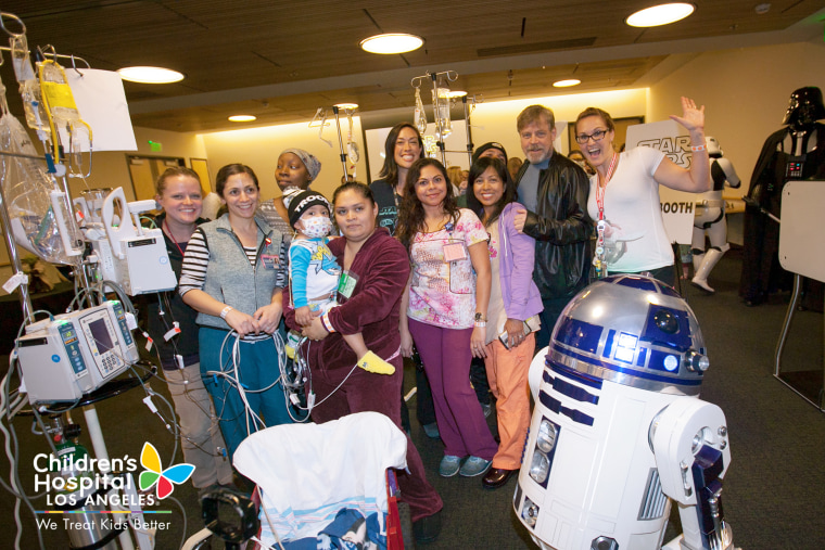 "Star Wars" star Mark Hamill joins a group of volunteers dressed as characters from the film franchise in visiting sick kids at Children's Hospital Los Angeles.