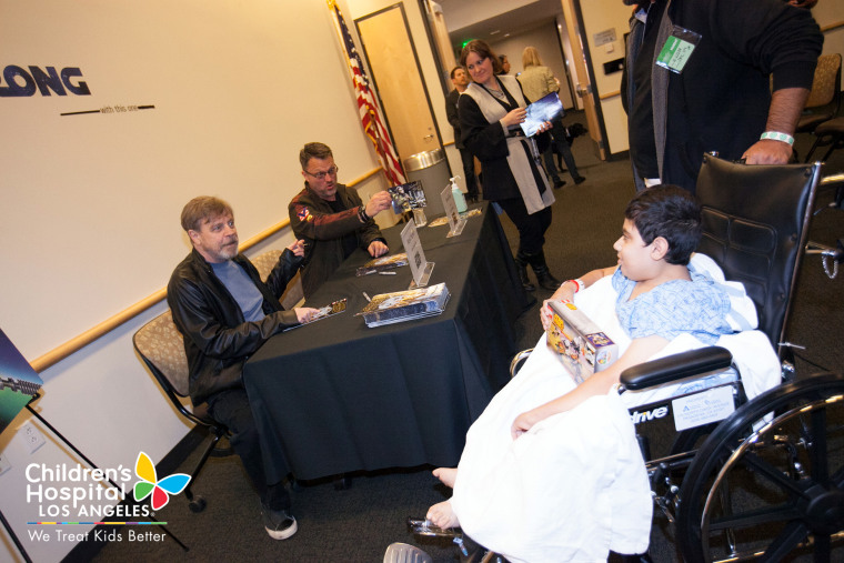 "Star Wars" star Mark Hamill and "Star Wars Rebels" voice-over artist Steven Blum sign autographs for fans at Children's Hospital Los Angeles.