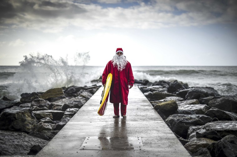 Image: TOPSHOT-ITALY-CHRISTMAS-SURF