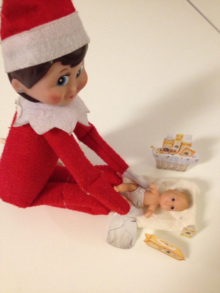 The Elf changes baby doll diapers! 