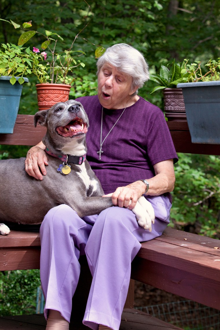 Sister Virginia Johnson gives Remy a hug at their home in Nyack, New York.