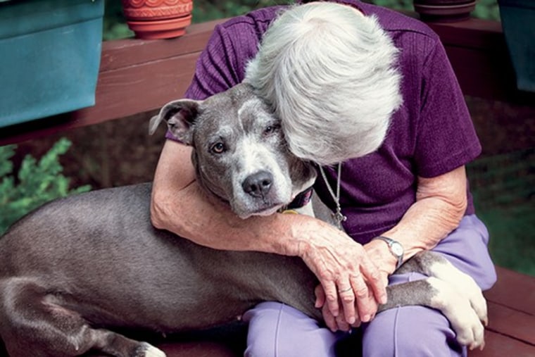 Sister Virginia Johnson gives Remy a hug at their home in Nyack, New York.