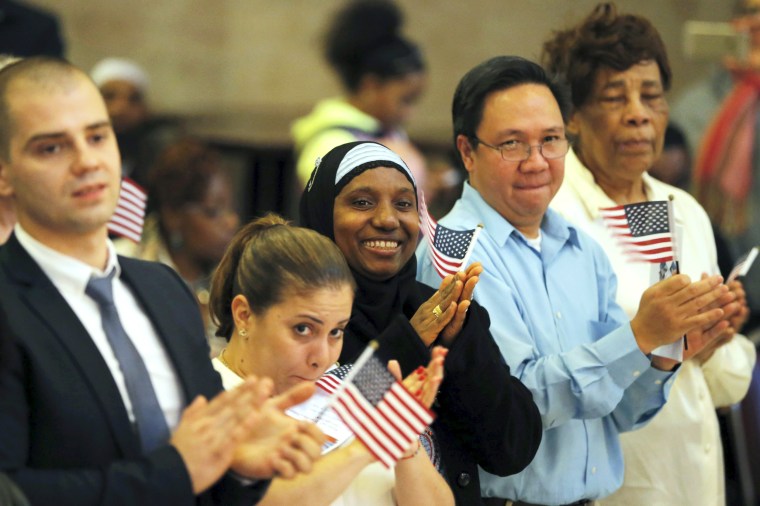 Image: Isatu Barrie smiles after taking part in the United States Oath of Citizenship during a naturalization ceremony in the Brooklyn borough of New York