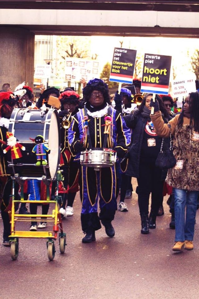 Protestors held signs saying “Zwarte Piet Should Not Be Here” and repeated, “ Zwarte Piet is Racism” as they walked behind a group of men donning blackface as Zwarte Piet.