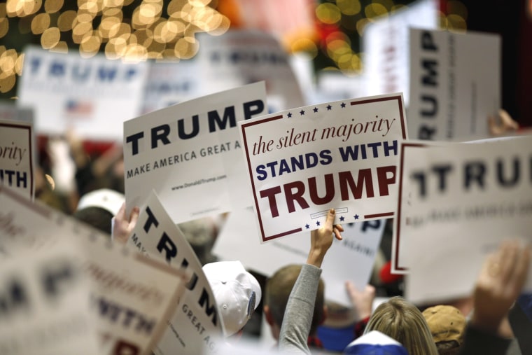Image: Supporters hold signs for U.S. Republican presidential candidate Trump at a campaign event at the Veterans Memorial Building in Cedar Rapids