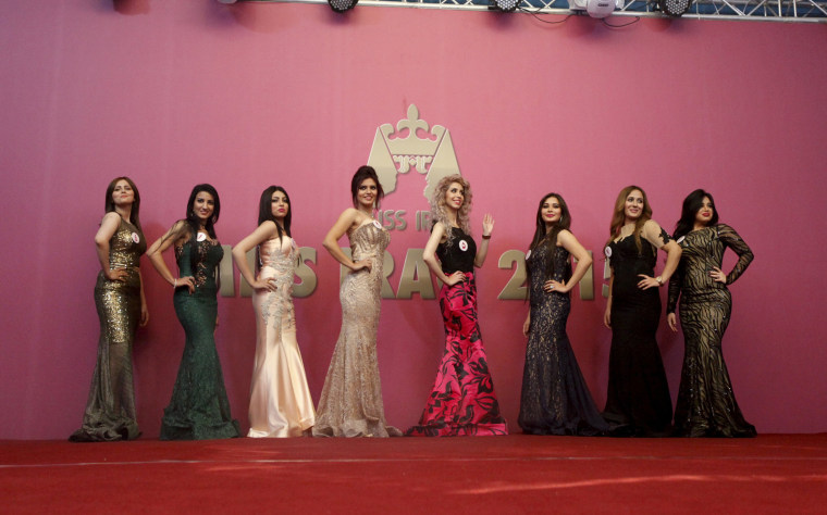 Image: Participants wait for judges to determine the winner of Miss Iraq during the final round of judging in Baghdad