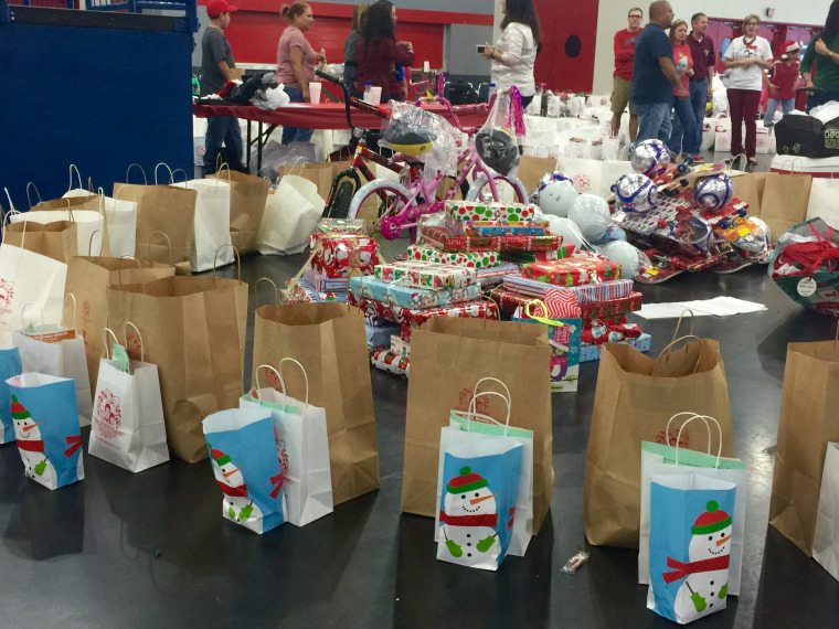 Gifts lined up for children at the "Navidad en el Barrio" event in Houston, TX.  It was started in 1985 by Israel Gomez when he was a police officer in the community.