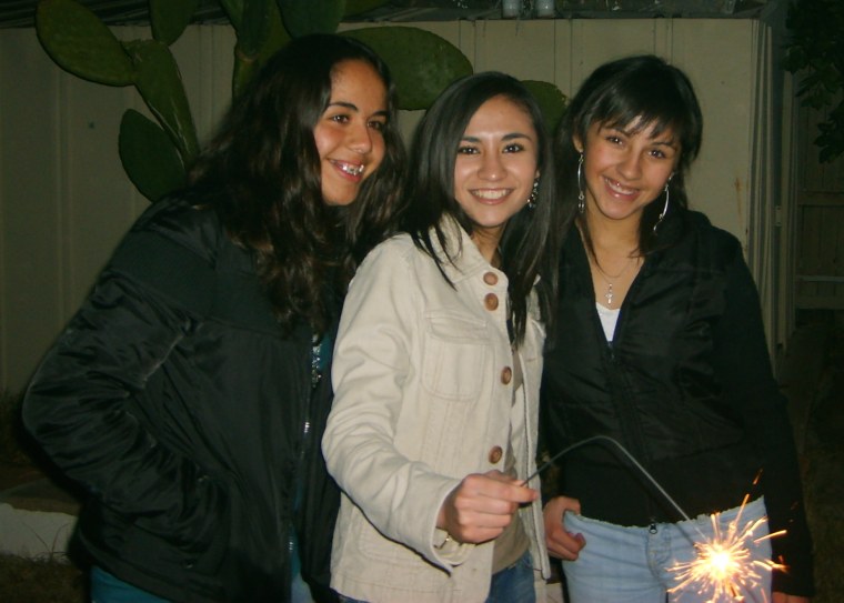 Griselda Nevarez (center) is surrounded by her cousins as they light up sparklers for Christmas.