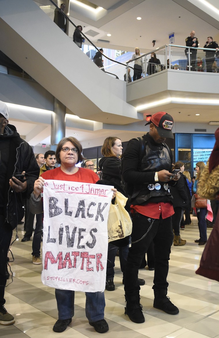 Image: Jess Sedin of Minneapolis held a sign during a Black Lives Matter protest at the Mall of America in Bloomington