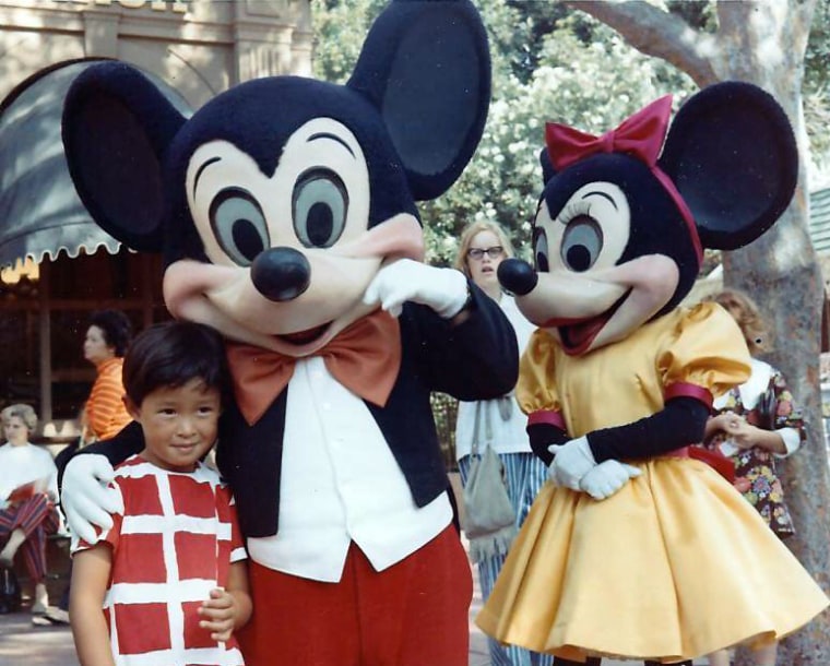 Frances Kai-Hwa Wang with American icons Mickey and Minnie Mouse at Disneyland in California.