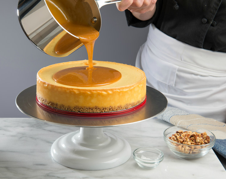 Pouring caramel on the Salted Caramel Flan Cheesecake; recipe courtesy of Eli's Cheesecake