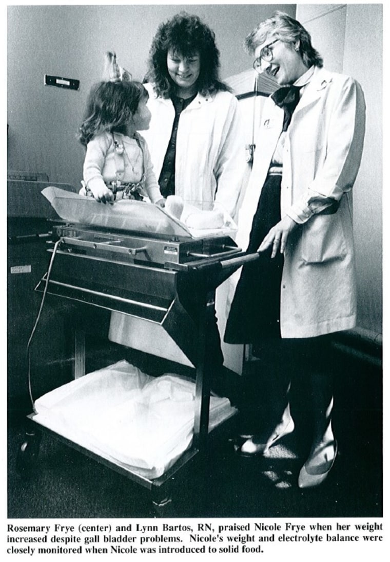 Nicole is weighed as her mom, center, and Bartos, right, look on in a photo featured in "Children's Nurse" in 1988.