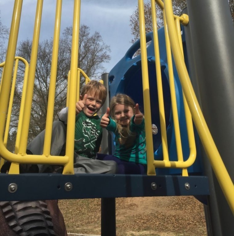 Kids on high section of playground equipment.