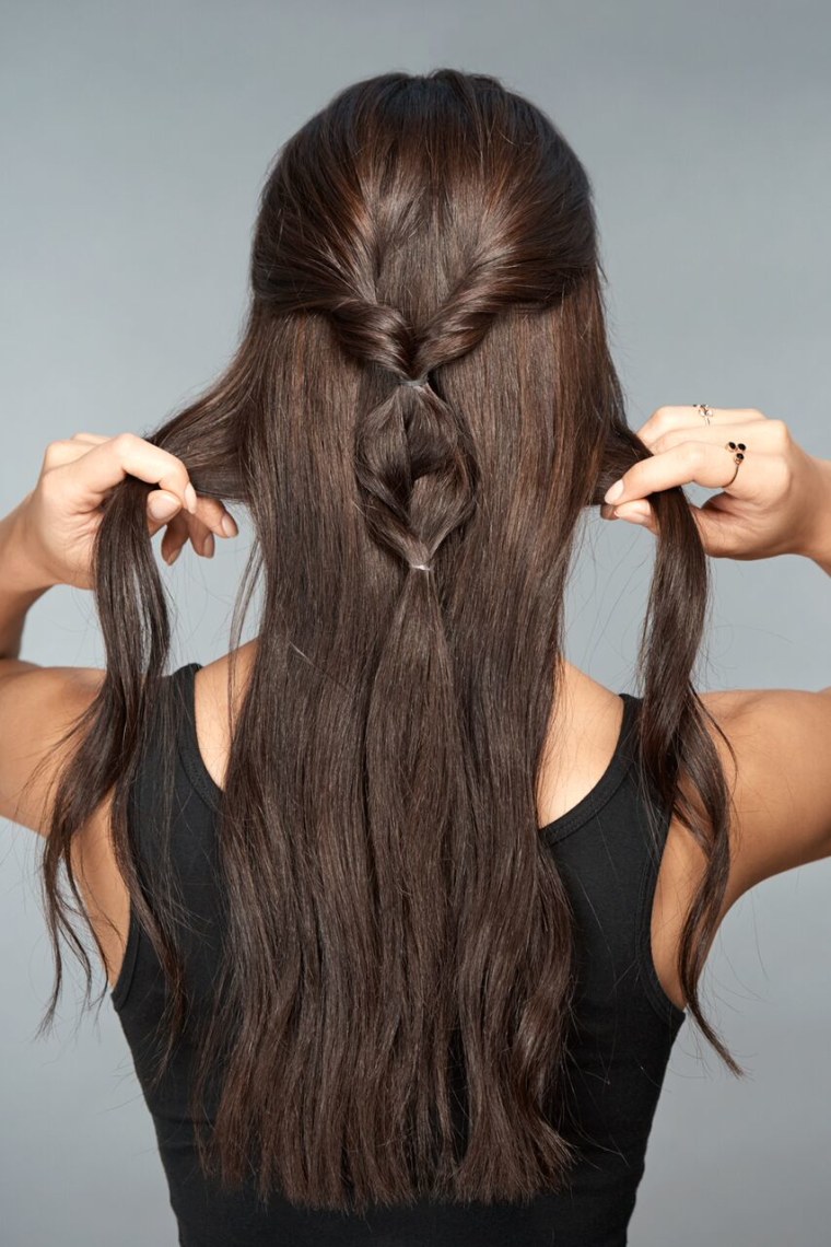 5) Grab small pieces of hair on either side and bring them toward the middle half ponytail.