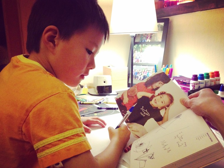 Sharon H. Chang's son with a copy of Kip Fulbeck's “Mixed: Portraits of Multiracial Kids.”