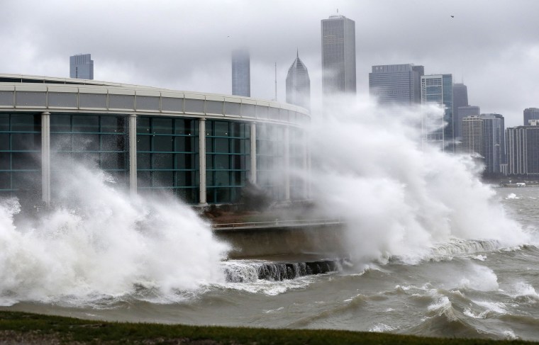 Image: Wind blown waves from Lake Michigan break around the Shedd Aquarium as a winter storm moves across Illinois on Monday in Chicago