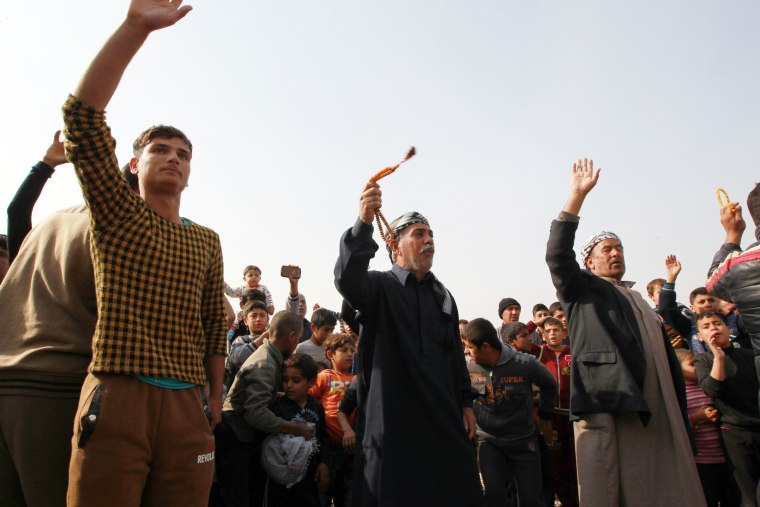 Image: Displaced Ramadi residents celebrate Tuesday after their city was liberated from ISIS.