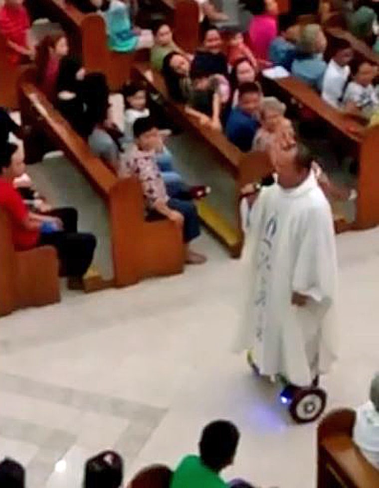 A priest rides a hoverboard in a church in the Philippines. 