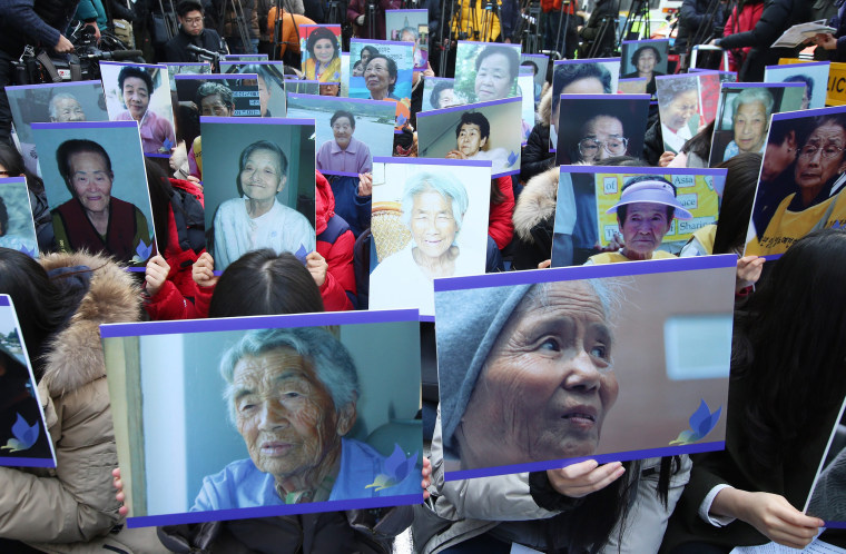 Image: South Korean supporters of former so-called comfort women, hold up pictures of deceased former comfort women