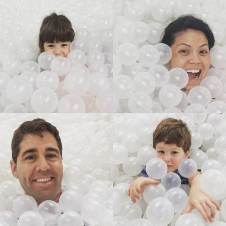 Angie Goff playing in a ball pit with her family