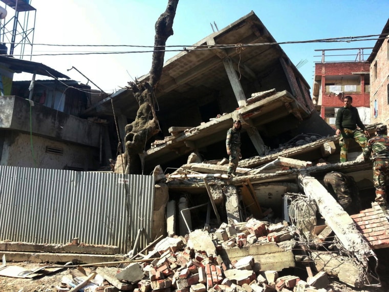 Soldiers inspect a house that collapsed in an earthquake in Imphal, capital of the northeastern Indian state of Manipur, on Jan. 4, 2016.