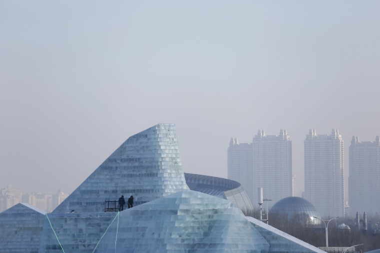 Image: Workers polish an ice sculpture ahead of the Harbin International Ice and Snow Festival in the northern city of Harbin