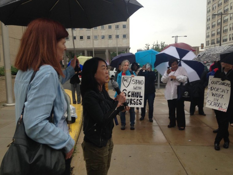 Helen Gym speaking with a group of school nurses. Gym, the first Asian-American woman to serve on the Philadelphia City Council, was elected on a platform of reinvesting in public schools.