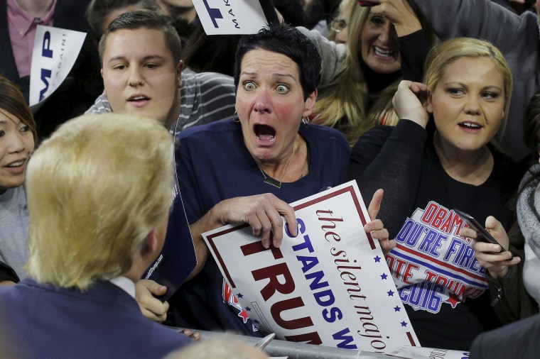 Image: Audience member Robin Roy reacts as U.S. Republican presidential candidate Donald Trump greets her at a campaign rally in Lowell