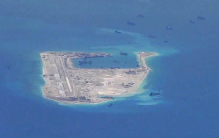 Image: Chinese dredging vessels are purportedly seen in the disputed Spratly Islands in the South China Sea in this U.S. Navy image taken on May 21.
