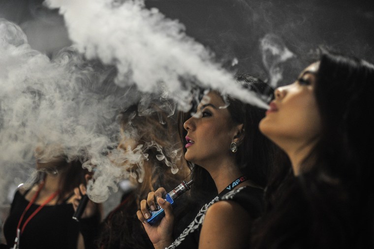 Promoters smoking electronic cigarettes during the Vape Fair in Kuala Lumpur. "Vaping" is soaring in popularity in Malaysia, the largest e-cigarette market in the Asia-Pacific region, but authorities are threatening to ban the habit in for health reasons — a move that has sparked anger from growing legions of aficionados.  