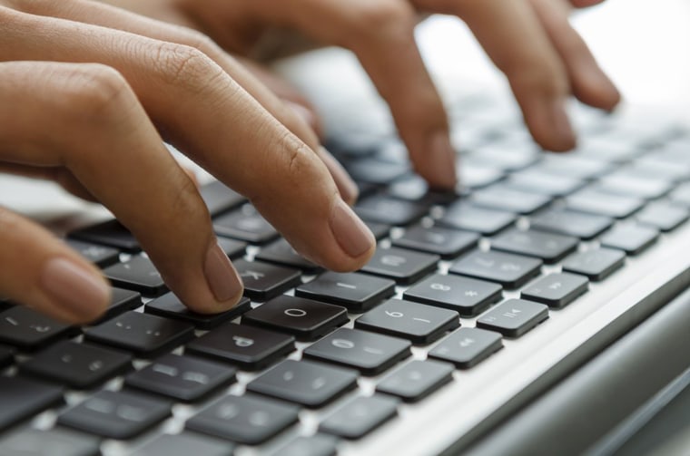 Image: Female hands typing on laptop
