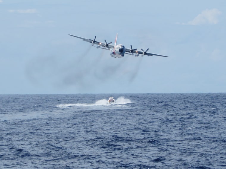 A Coast Guard C-130 flies over a vessel carrying Cuban migrants off the coast of Mexico's Yucatan. The migrants were safely removed from the vessel and repatriated to Cuba.