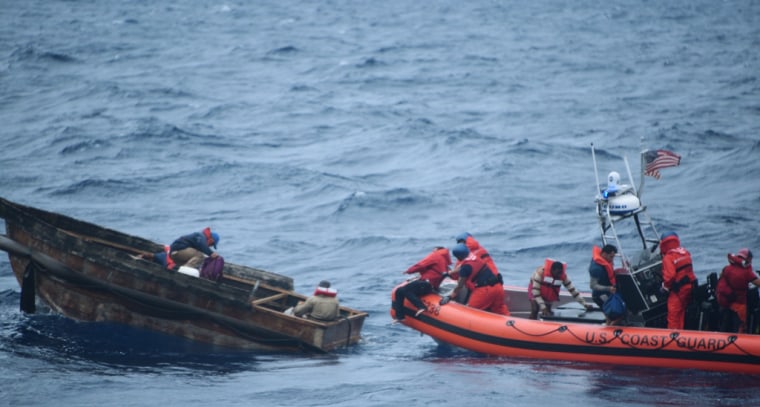 A Coast Guard crew pulls Cuban migrants from the water south of Marquesas, Florida. The migrants jumped from their rustic vessel into the
water for rescue.