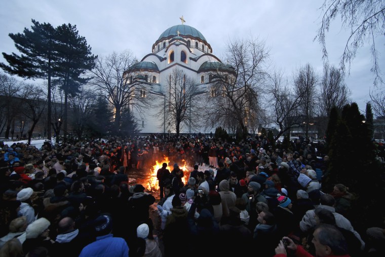 Image: Believers burn dried oak branches on Orthodox Christmas Eve in Belgrade