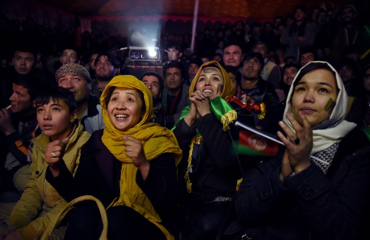 Image: Afghan soccer fans cheer for their national team as they watch a live broadcast of the SAFF Championship match