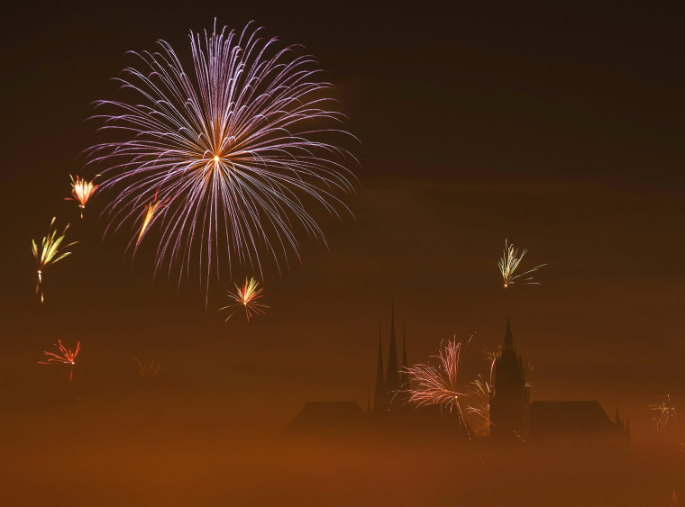 Image: Fireworks light the sky above the medieval Mariendom