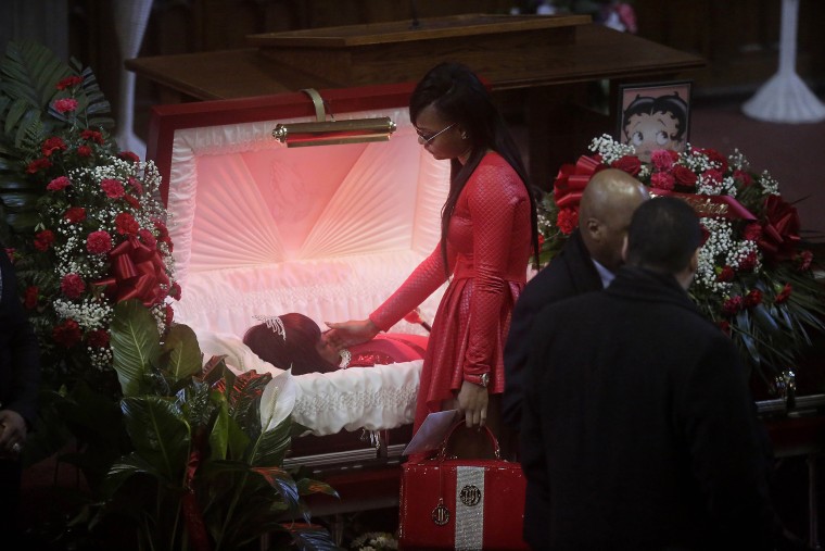 Image: LaTonya Jones stands over her mother Bettie Jones during her funeral