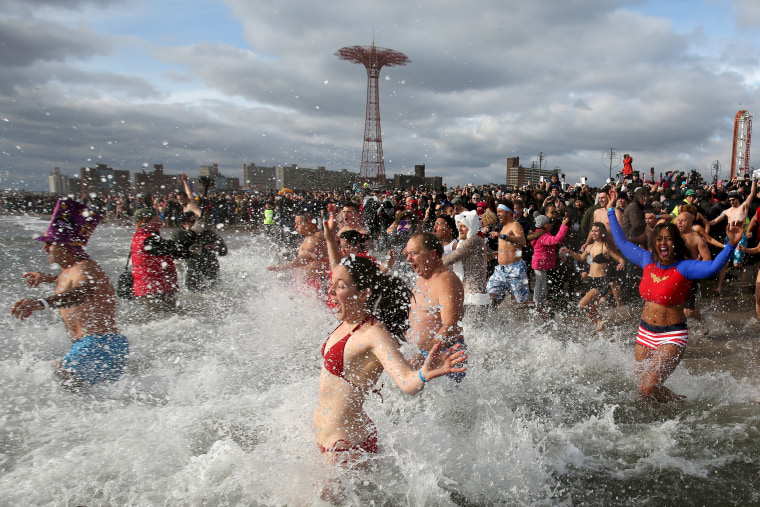 Image: Participants enter the water during the Coney Island Polar Bear Club's annual New Year's Day swim