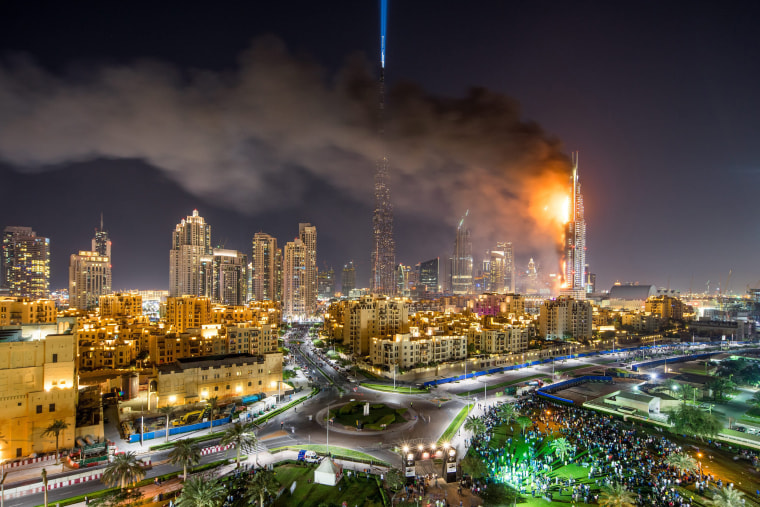 Image: Flames and smoke billow from a building after a fire broke out at the The Address Hotel in Dubai