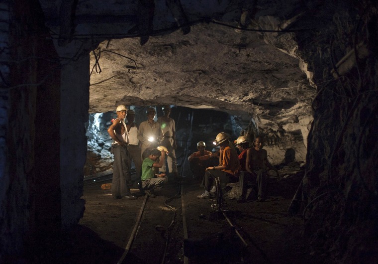 Image: File photo of miners resting inside an underground Barora coal mine at Dhanbad district