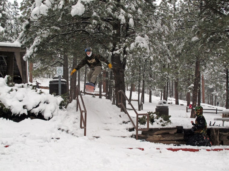 Image: Zach Bednar hits a ramp while snowboarding in Flagstaff, Ariz.
