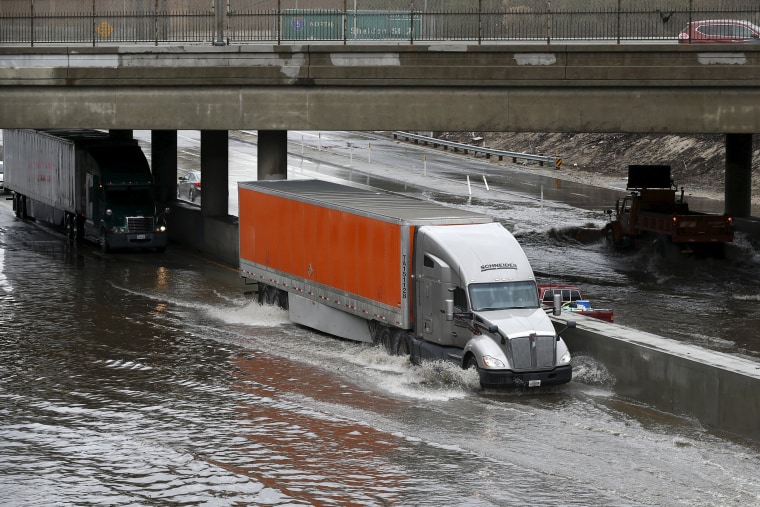 Image: Trucks drive on the flooded 5 freeway after an El Nino-strengthened storm brought rain to Los Angeles