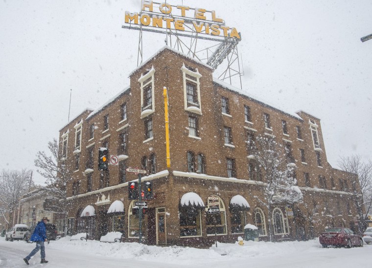 Image: A pedestrian crosses in front of the Monte Vista Hotel