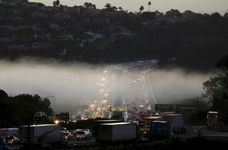 Image: Morning commuter traffic travels through a section of ground fog following an El Nino-strengthened storm in Solana Beach, Calif.